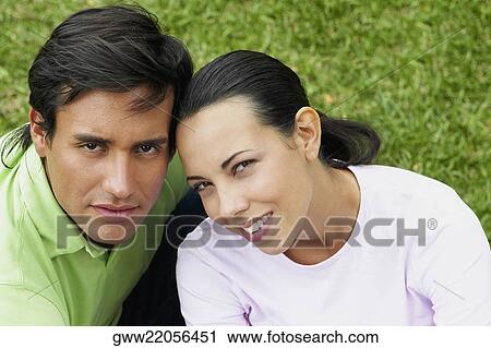 Portrait of a young couple sitting on a picnic blanket View Large Photo Image Stock Image - Portrait of a young couple sitting on a picnic blanket. Fotosearch