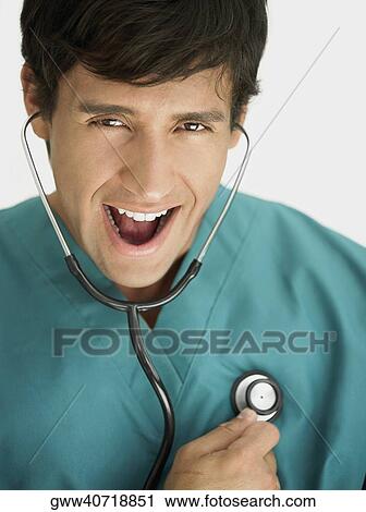 Portrait of a young male doctor wearing a stethoscope View Large Photo Image Stock Image - Portrait of a young male doctor wearing a stethoscope. Fotosearch
