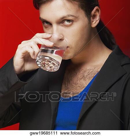 Portrait of a young man drinking water View Large Photo Image Stock Image - Portrait of a young man drinking water. Fotosearch