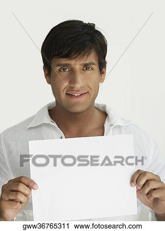 Portrait of a young man holding a placard View Large Photo Image Stock Image - Portrait of a young man holding a placard. Fotosearch
