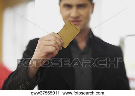 Portrait of a young man holding a credit card View Large Photo Image Stock Image - Portrait of a young man holding a credit card. Fotosearch