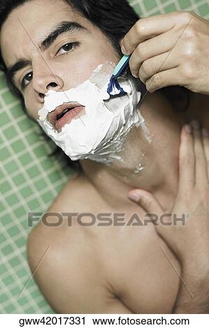 Portrait of a young man shaving View Large Photo Image Stock Image - Portrait of a young man shaving. Fotosearch