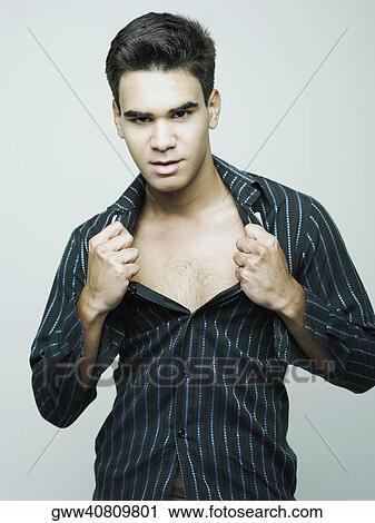 Portrait of a young man showing his chest View Large Photo Image Stock Image - Portrait of a young man showing his chest. Fotosearch