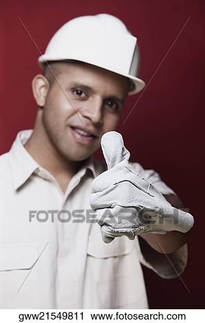 Portrait of a young man showing thumbs up sign View Large Photo Image Stock Image - Portrait of a young man showing thumbs up sign. Fotosearch