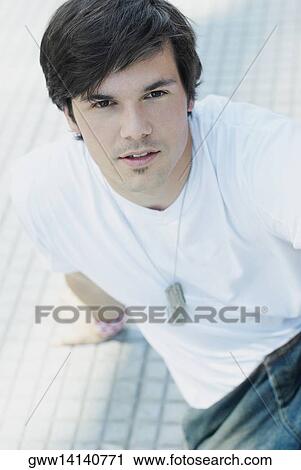 Portrait of a young man sitting on the floor View Large Photo Image Stock Image - Portrait of a young man sitting on the floor. Fotosearch