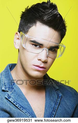 Portrait of a young man wearing protective eyewear View Large Photo Image Stock Image - Portrait of a young man wearing protective eyewear. Fotosearch