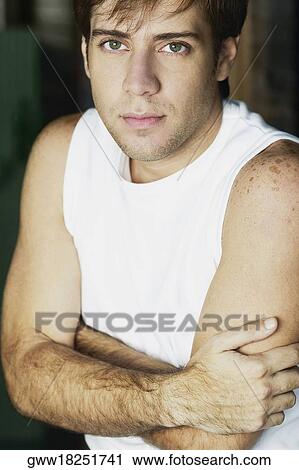 Portrait of a young man with his arms crossed View Large Photo Image Stock Image - Portrait of a young man with his arms crossed. Fotosearch