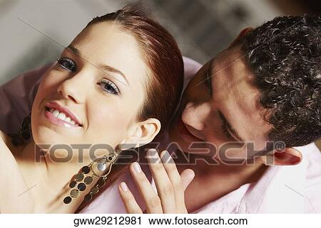Stock Image - Portrait of a young woman and a teenage boy smiling. Fotosearch