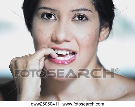 Portrait of a young woman biting her nails View Large Photo Image Stock Image - Portrait of a young woman biting her nails. Fotosearch