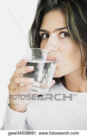 Portrait of a young woman drinking water View Large Photo Image Stock Image - Portrait of a young woman drinking water. Fotosearch