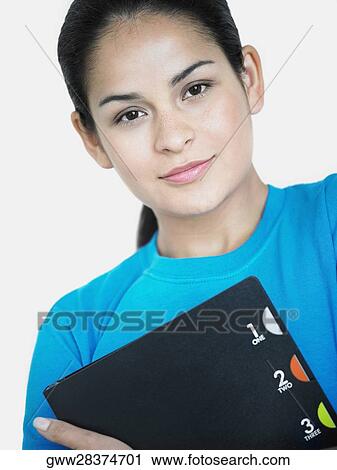 Portrait of a young woman holding a file View Large Photo Image Stock Image - Portrait of a young woman holding a file. Fotosearch