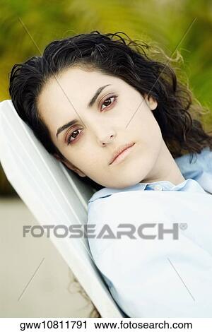 Portrait of a young woman looking serious View Large Photo Image Stock Image - Portrait of a young woman looking serious. Fotosearch