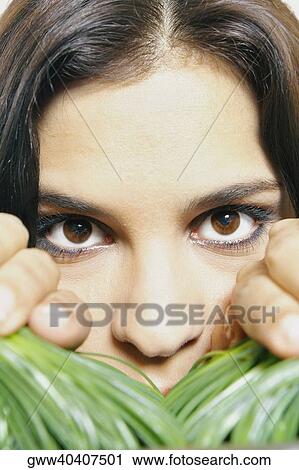 Portrait of a young woman separating wheatgrass with her hands View Large Photo Image Stock Image - Portrait of a young woman separating wheatgrass with her hands. Fotosearch