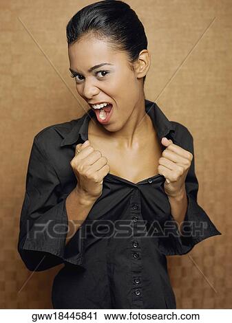 Portrait of a young woman shouting and pulling her clothes View Large Photo Image Stock Image - Portrait of a young woman shouting and pulling her clothes. Fotosearch