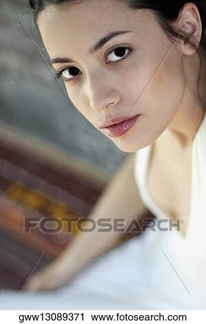 Stock Image - Portrait of a young woman thinking. Fotosearch