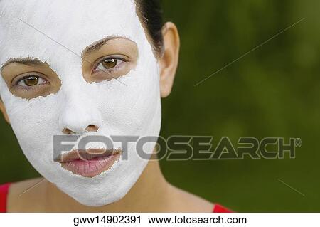 Portrait of a young woman wearing a facial mask View Large Photo Image Stock Image - Portrait of a young woman wearing a facial mask. Fotosearch