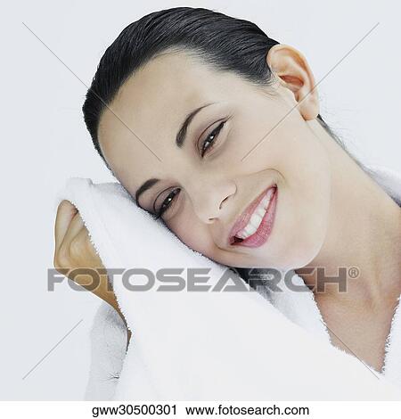 Portrait of a young woman wiping her face with a towel View Large Photo Image Stock Image - Portrait of a young woman wiping her face with a towel. Fotosearch