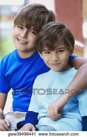 Stock Image - Portrait of two boys smiling. Fotosearch