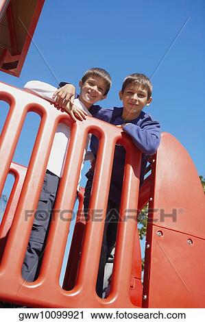 Portrait of two brothers smiling and standing together View Large Photo Image Stock Image - Portrait of two brothers smiling and standing together. Fotosearch