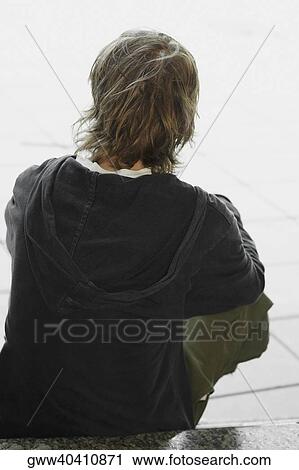 Rear view of a teenage boy sitting View Large Photo Image Stock Image - Rear view of a teenage boy sitting. Fotosearch