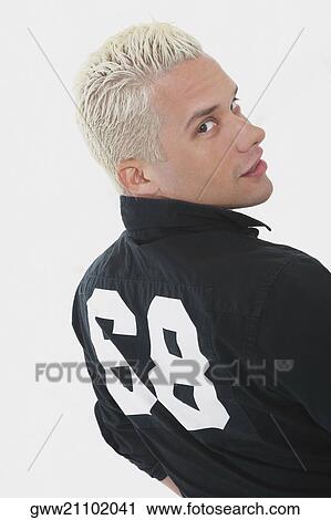 Rear view of a young man looking over shoulders View Large Photo Image Stock Image - Rear view of a young man looking over shoulders. Fotosearch