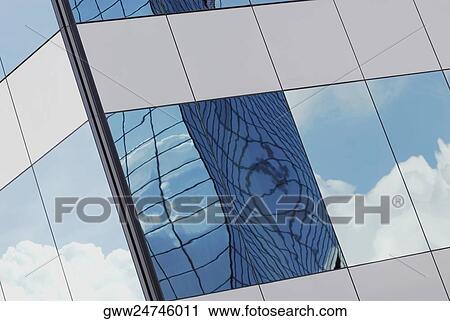 Reflection of clouds on the glass of a building View Large Photo Image Stock Image - Reflection of clouds on the glass of a building. Fotosearch