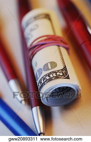 Rolled up American banknotes with pens View Large Photo Image Stock Image - Rolled up American banknotes with pens. Fotosearch