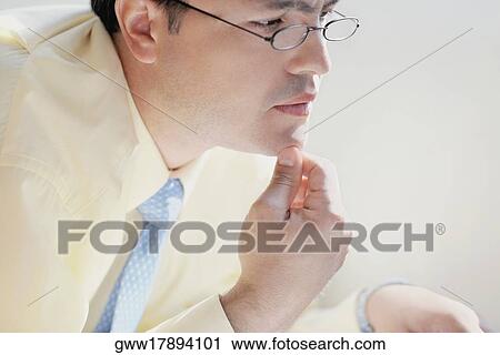 Side profile of a mid adult man with his hand on his chin View Large Photo Image Stock Image - Side profile of a mid adult man with his hand on his chin. Fotosearch
