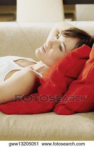 Side profile of a young woman lying on the couch View Large Photo Image Stock Image - Side profile of a young woman lying on the couch. Fotosearch