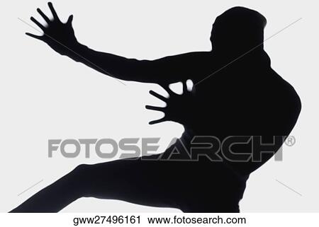 Stock Image - Silhouette of a person dancing. Fotosearch