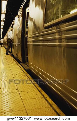 Train at a railroad station platform View Large Photo Image Stock Image - Train at a railroad station platform. Fotosearch