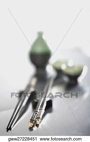 Two pairs of chopsticks with Chinese tea in the background View Large Photo Image Stock Image - Two pairs of chopsticks with Chinese tea in the background. Fotosearch