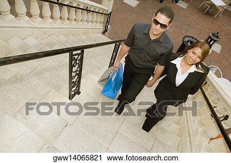Young couple moving up on the steps View Large Photo Image Stock Image - Young couple moving up on the steps. Fotosearch