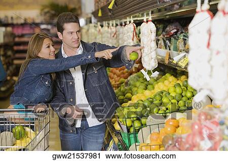 Stock Image - Young couple shopping in a supermarket. Fotosearch