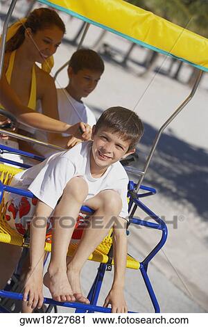 Young woman and two boys in a buggy View Large Photo Image Stock Image - Young woman and two boys in a buggy. Fotosearch