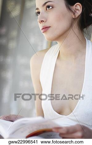 Young woman holding a book View Large Photo Image Stock Image - Young woman holding a book. Fotosearch