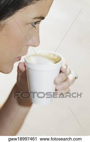 Young woman holding a cup of coffee View Large Photo Image Stock Image - Young woman holding a cup of coffee. Fotosearch