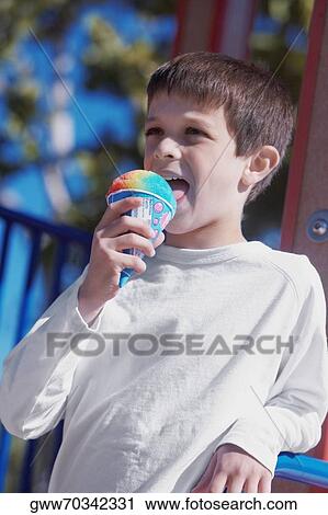 Boy licking an ice-cream View Large Photo Image Stock Image - Boy licking an ice-cream. Fotosearch