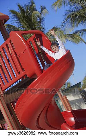 Boy sliding down a slide View Large Photo Image Stock Image - Boy sliding down a slide. Fotosearch