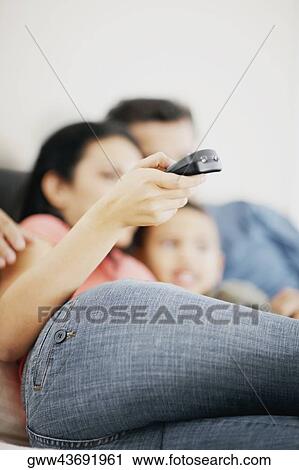 Boy watching television with his parents View Large Photo Image Stock Image - Boy watching television with his parents. Fotosearch