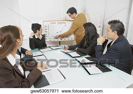 Businessman giving a presentation to business executives View Large Photo Image Stock Image - Businessman giving a presentation to business executives. Fotosearch