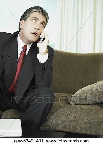 Businessman talking on a mobile phone View Large Photo Image Stock Image - Businessman talking on a mobile phone. Fotosearch