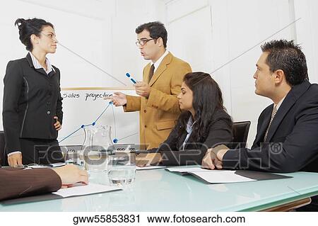Businessmen and businesswomen in a conference room View Large Photo Image Stock Image - Businessmen and businesswomen in a conference room. Fotosearch