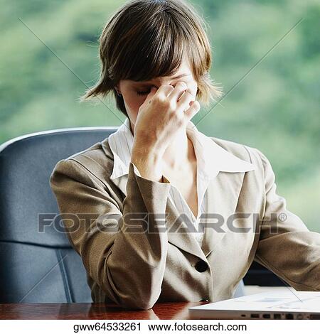Businesswoman sitting in an office and looking worried View Large Photo Image Stock Image - Businesswoman sitting in an office and looking worried. Fotosearch