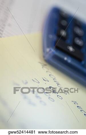 Calculator on a sheet of paper View Large Photo Image Stock Image - Calculator on a sheet of paper. Fotosearch