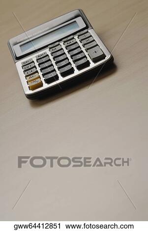 Stock Image - Calculator on the table. Fotosearch