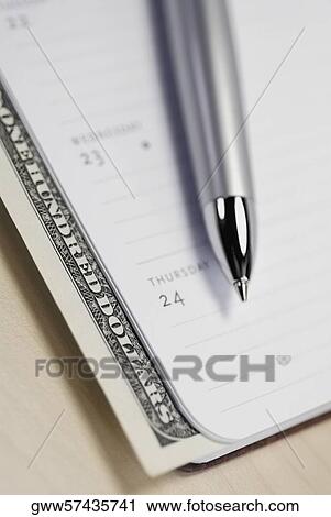 Close-up of a ballpoint pen and a diary on the table View Large Photo Image Stock Image - Close-up of a ballpoint pen and a diary on the table. Fotosearch