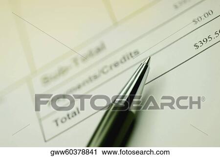 Stock Image - Close-up of a ballpoint pen on a bill. Fotosearch