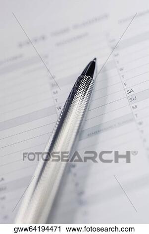 Stock Image - Close-up of a ballpoint pen on a personal organizer. Fotosearch