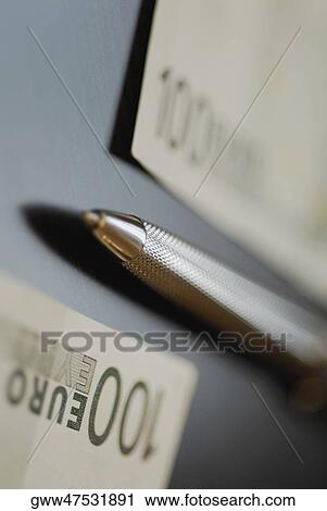 Close-up of a ballpoint pen with two Euro notes View Large Photo Image Stock Image - Close-up of a ballpoint pen with two Euro notes. Fotosearch